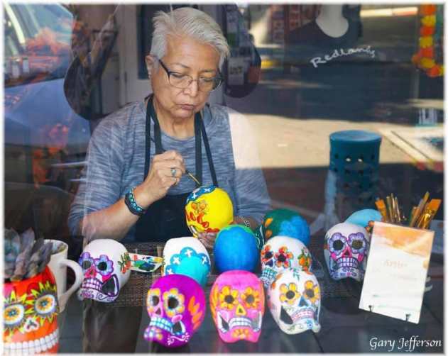 Sylvia painting skulls for the day of the dead